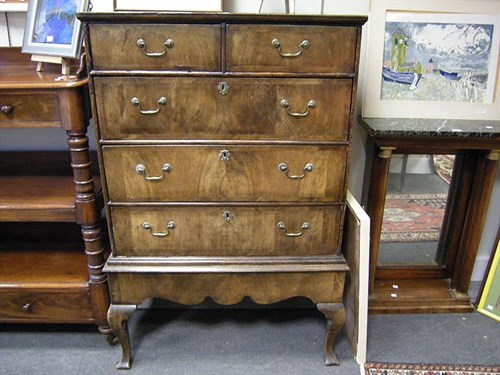 Lot 48 - A walnut chest on stand