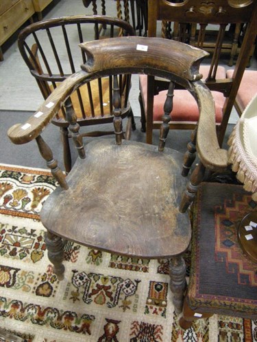Lot 103 - An elm captain's chair