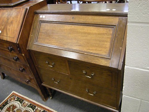 Lot 71 - An oak upright bureau on stretchered supports