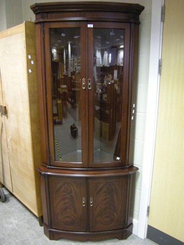 Lot 142 - A reproduction bowfront corner cupboard