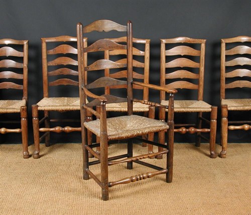 Lot 657 - A set of six rush seated ash ladder backed chairs