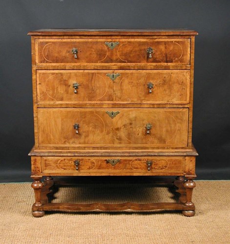Lot 658 - An early 18th century walnut chest on stand