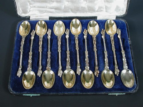 Lot 245 - A set of twelve silver gilt figural teaspoons