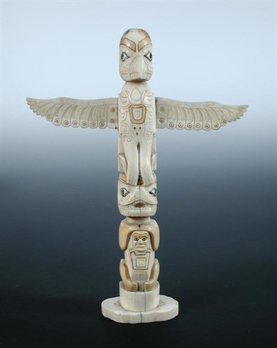 Lot 559 - A North West Coast native American walrus ivory totem