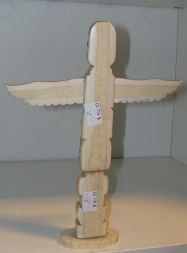 Lot 559 - A North West Coast native American walrus ivory totem