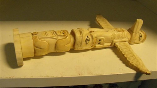 Lot 559 - A North West Coast native American walrus ivory totem
