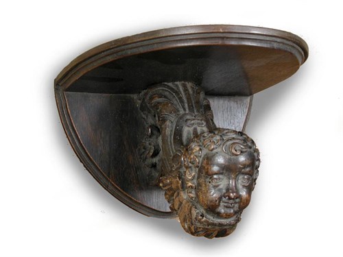 Lot 601 - A pair of 17th century walnut cherubs converted to wall brackets