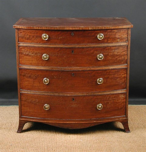 Lot 688 - A Sheraton mahogany bow front chest of drawers