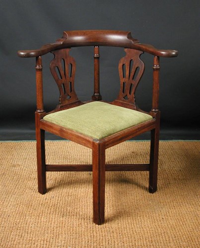 Lot 689 - A George III mahogany corner armchair