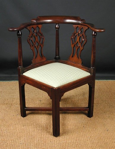 Lot 690 - A George III mahogany corner armchair