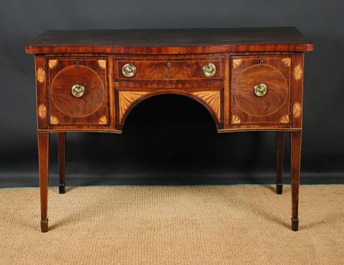 Lot 691 - A Sheraton mahogany serpentine sideboard, circa 1800
