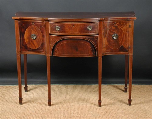 Lot 667 - A small George III revival serpentine mahogany sideboard