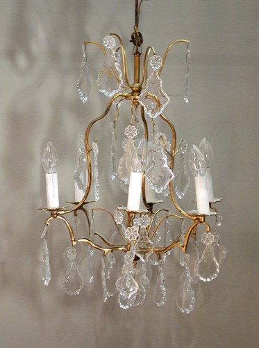 Lot 737 - A pair of Baccarat glass and gilt metal six light chandeliers