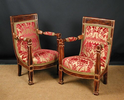 Lot 709 - A pair of French Empire faux rosewood and parcel gilt armchairs