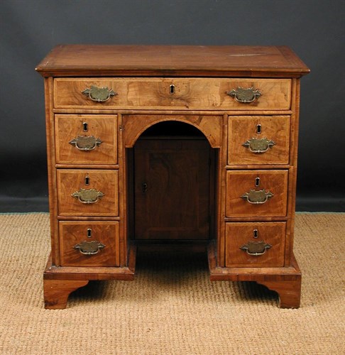Lot 652 - An 18th century oak and walnut kneehole desk