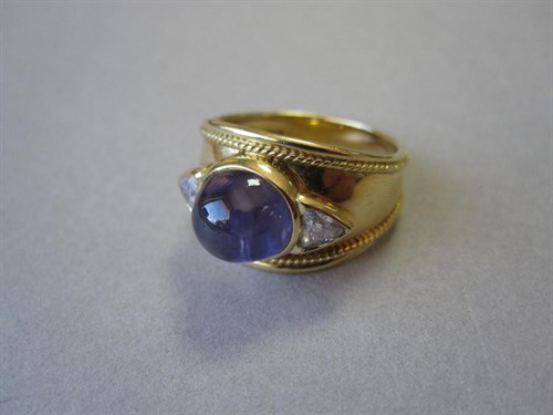 Lot 168 - An 18ct gold, star sapphire and diamond three stone ring by David Tinsley
