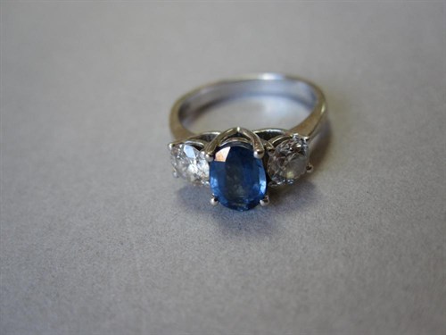 Lot 182 - A sapphire and diamond three stone ring in 18ct white gold