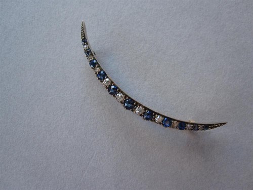 Lot 178 - A sapphire and diamond open crescent brooch