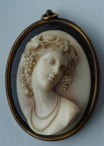 Lot 565 - A mid 19th century ivory relief profile of a lady