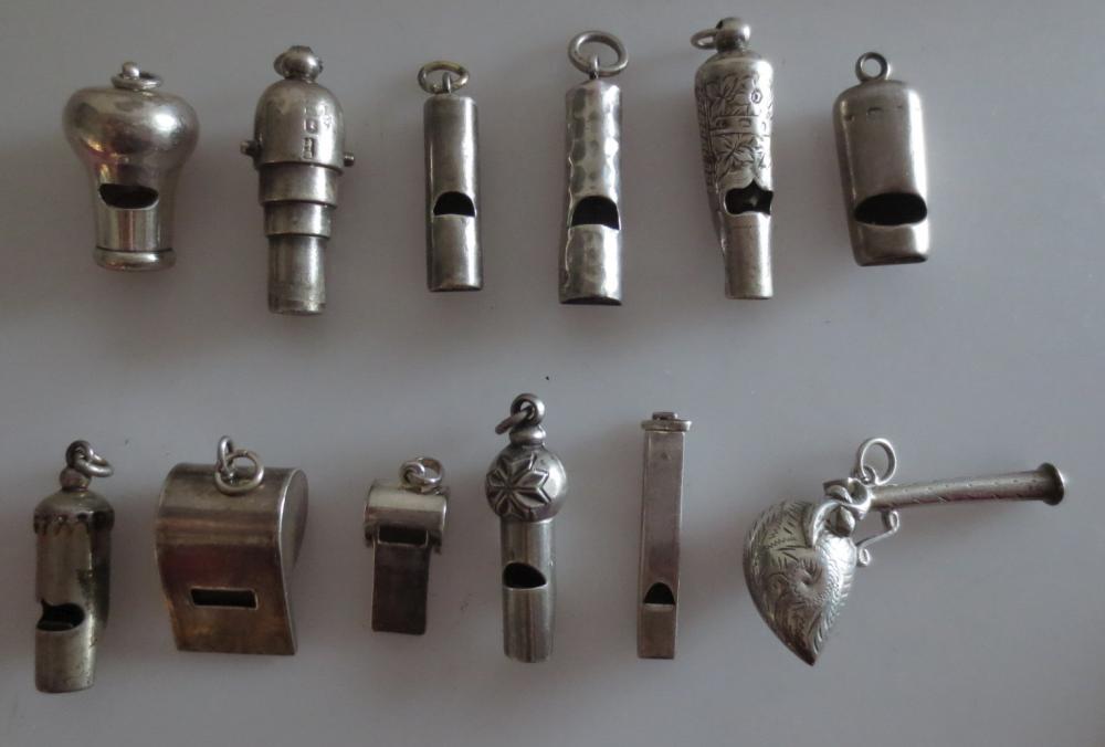 Lot 399 - A group of twelve miniature silver whistles