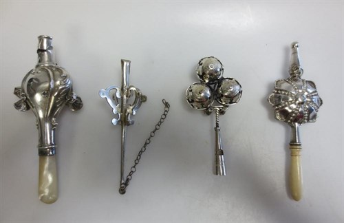 Lot 404 - Four various silver whistle and bell rattles