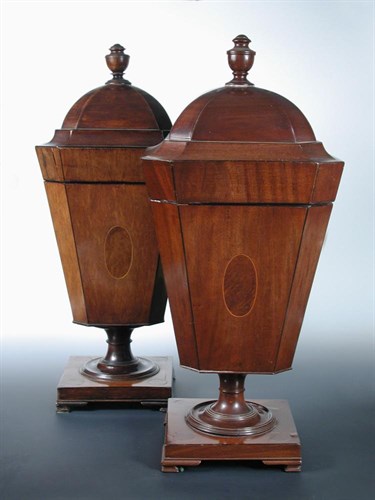 Lot 870 - A matched pair of George IV and later mahogany pedestal knife urns