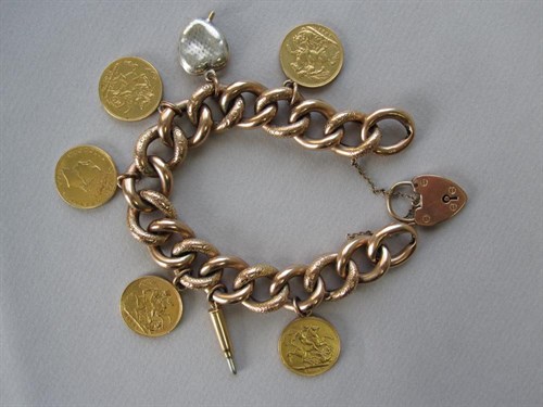 Lot 116 - An antique 9ct rose gold charm bracelet with five gold sovereigns