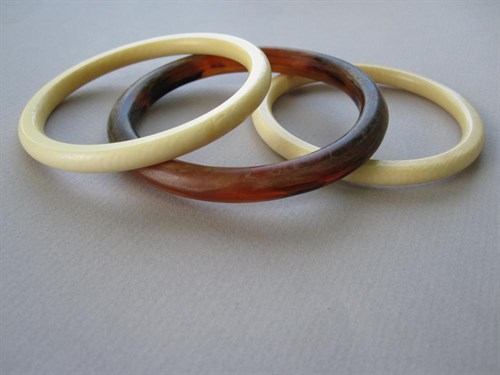 Lot 164 - Two ivory bangles together with a similar tortoiseshell bangle
