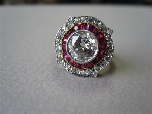 Lot 242 - A diamond and ruby art deco target ring