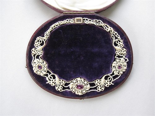 Lot 155 - A Victorian seed pearl and amethyst swag necklace in a fitted case together with a pair of similar earpendants