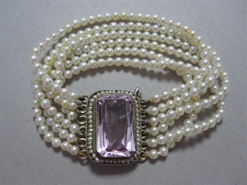 Lot 143 - A six row pearl bracelet with pink spinel and seed pearl clasp