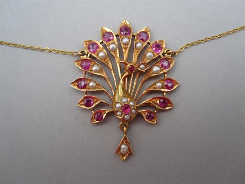 Lot 253 - A ruby and seed pearl peacock necklace