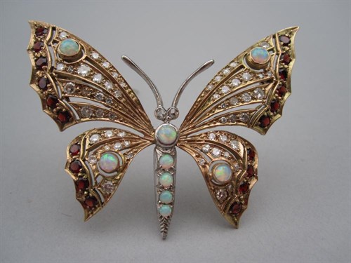 Lot 216 - An opal, diamond and garnet butterfly brooch