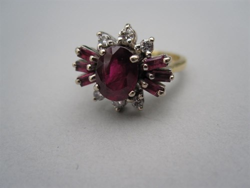 Lot 246 - A ruby and diamond cluster ring set in 18ct gold