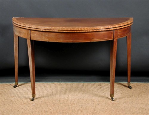 Lot 834 - A George III mahogany demi-lune card table,...