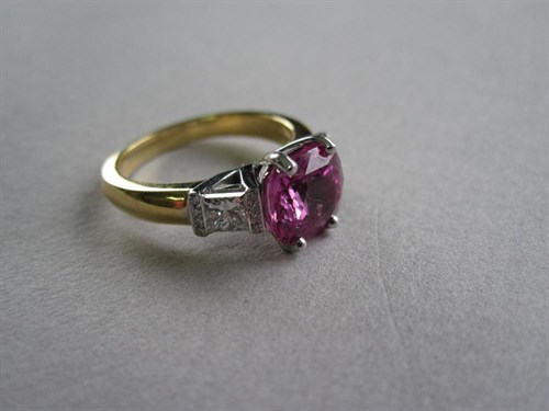 Lot 252 - A three stone pink sapphire and diamond ring in 18ct gold