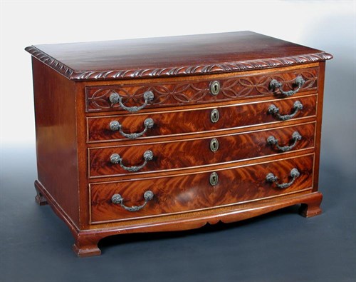 Lot 683 - An early 20th century bow front miniature chest of four graded drawers