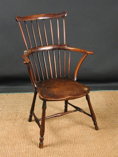Lot 821 - A small 18th century ash and elm comb back chair