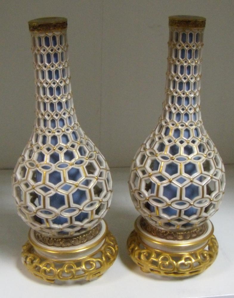 Lot 15 - A matched pair of Royal Worcester reticulated bottle vases, date letters for 1879 and 1884