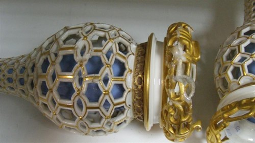 Lot 15 - A matched pair of Royal Worcester reticulated bottle vases, date letters for 1879 and 1884