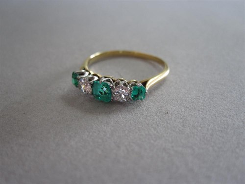 Lot 198 - An emerald and diamond five stone ring