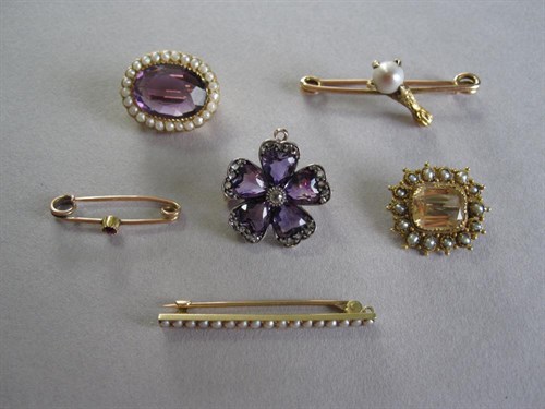 Lot 139 - A 19th century amethyst and diamond flowerhead brooch together with five other gemset brooches and pins