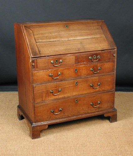 Lot 845 - A George III elm bureau, circa 1770